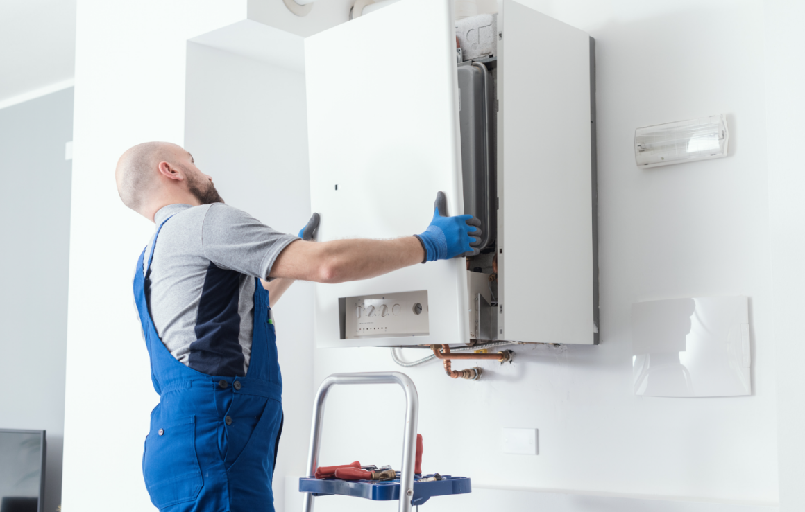 A worker installing a boiler